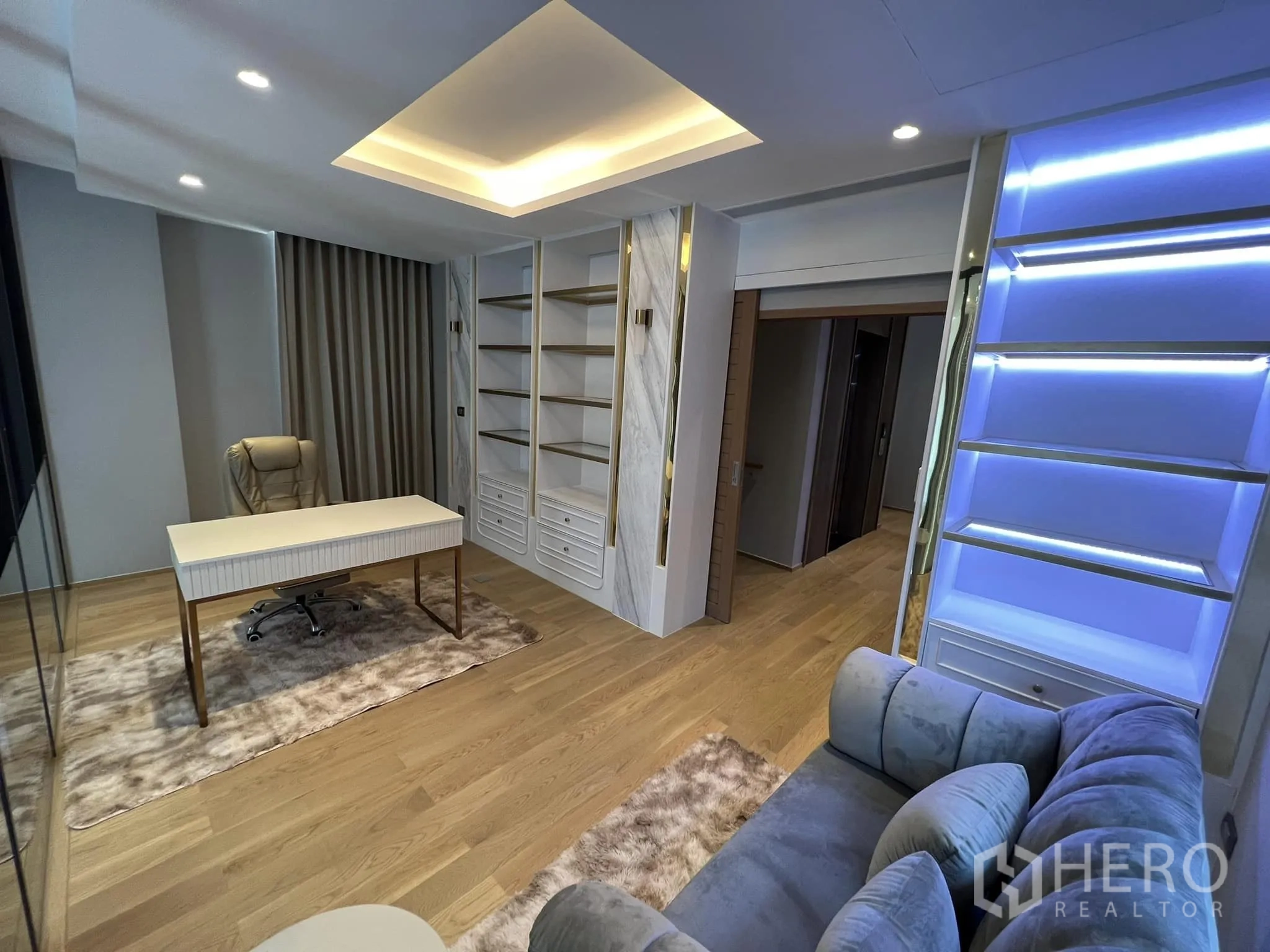 Detached House for rent or sale in Yan Nawa, Bangkok - Home office corner with illuminated display shelves and sofa.