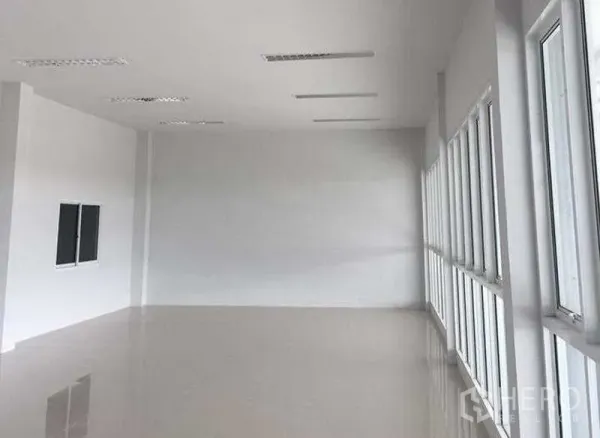 Warehouse for rent in Bang Bo, Samut Prakan - Bright second-floor office space with white walls, tiled floor and rows of windows.