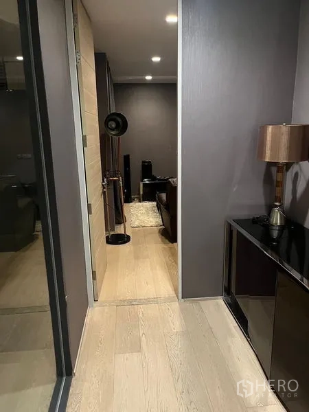 Detached House for rent in Wang Thonglang, Bangkok - Corridor leading to a media room with speakers, rug, and a floor lamp.