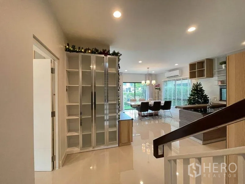 บ้าน ขายในPak Kret, Nonthaburi - พื้นที่ทานอาหารและครัวแบบเปิด พื้นเงา ตู้กระจก และประตูกระจกเปิดสู่สวน