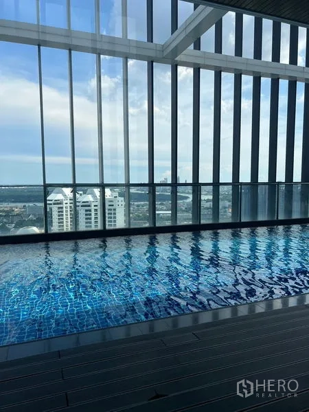 Condominium for sale - City-view swimming pool with glass enclosure and deck.
