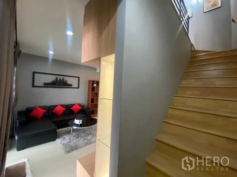 Home Office for rent or sale in Bang Phli, Samut Prakan - Wood staircase with handrail next to the living area in a modern home office.