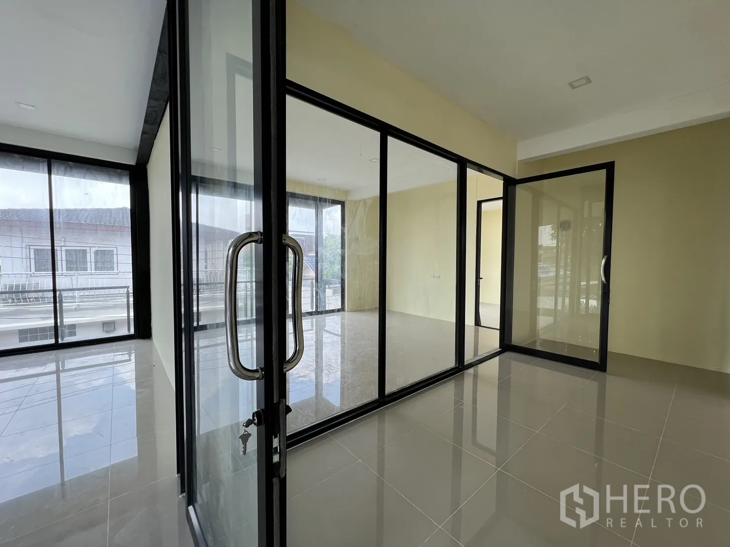 Detached House for rent or sale in Phra Khanong, Bangkok - Upper floor with sliding glass partitions and access to balcony.