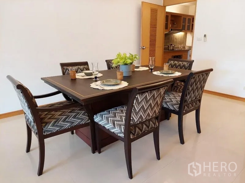 Apartment for rent - Dining area set for a meal beside the doorway to the kitchen.