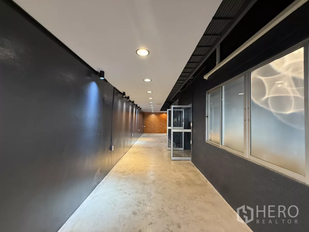 办公空间 出租在Wang Thonglang, Bangkok - 长走道，轨道灯、磨砂窗与水泥地面。