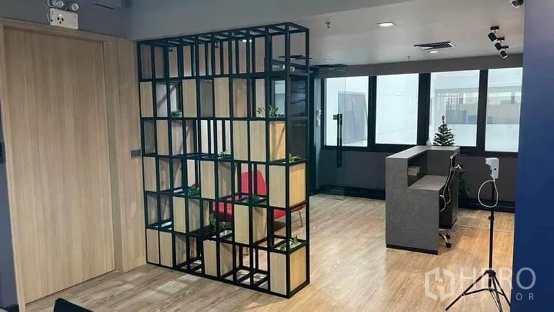 Office Space for rent in Khlong Toei, Bangkok - Reception zone with a metal grid divider, wood floors and abundant natural light.