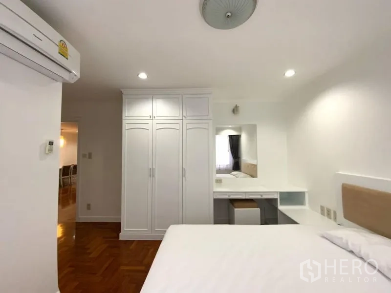 公寓 出租在Watthana, Bangkok - 第二卧室设嵌入式衣柜、梳妆台与温暖木地板。