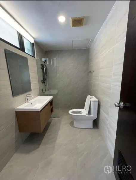 Condominium for rent - Modern bathroom with wide vanity, walk-in shower and neutral tiles.