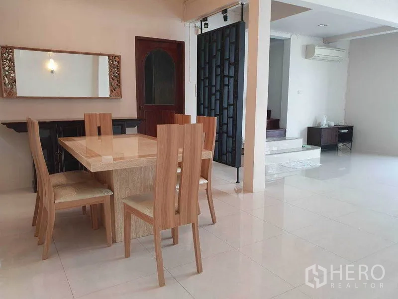 Detached House for rent in Phra Khanong, Bangkok - Open-plan dining connected to living space with glossy tiles and air conditioning.