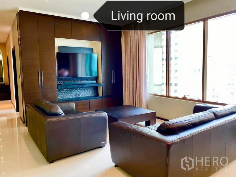 Condominium for rent - Another view of the living room showing TV feature wall and full-height windows