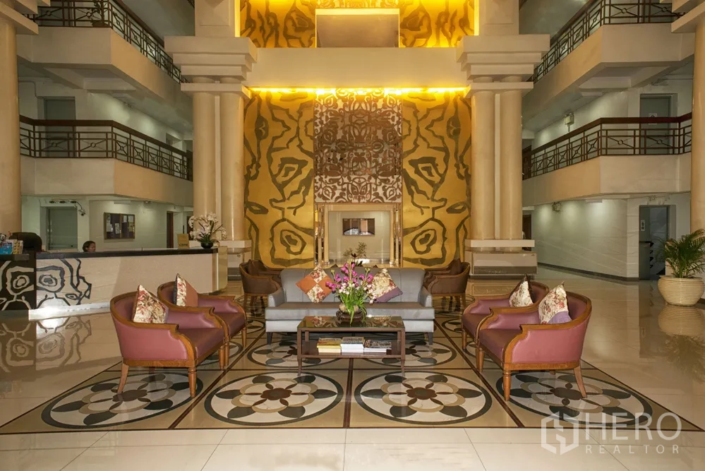 Condominium for rent or sale in Watthana, Bangkok - Elegant condo lobby with high ceiling, pillars, and comfortable seating.