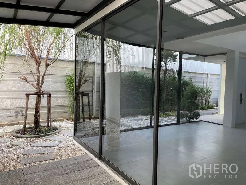 Home Office for rent in Don Mueang, Bangkok - Covered terrace with floor-to-ceiling glass looking onto a pebble garden.