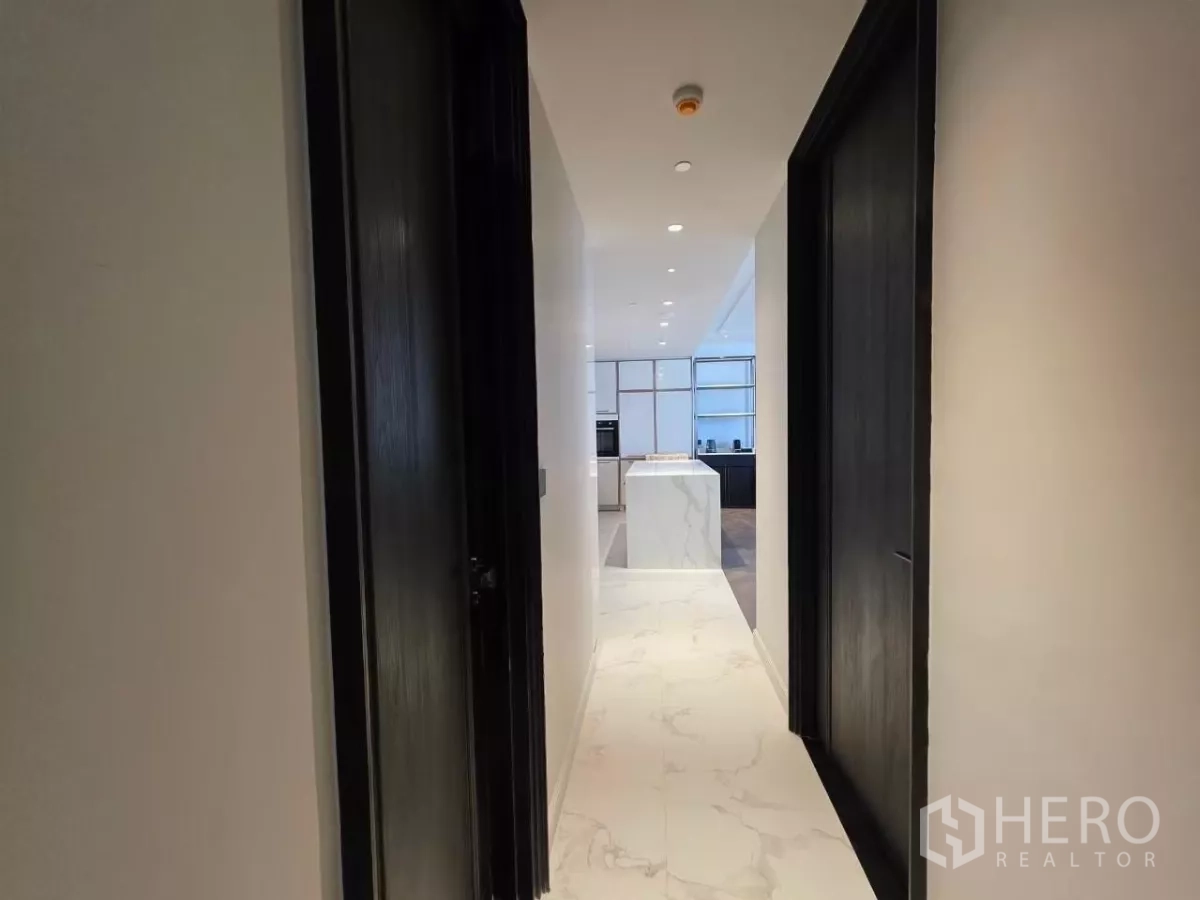 Condominium for rent - Guest bathroom vanity by a city-view window with blue decorative tile.