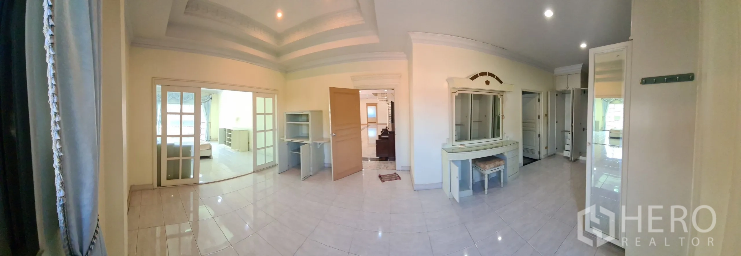 Detached House for sale in Chatuchak, Bangkok - Large bedroom suite with sliding doors and built-in dressing table.