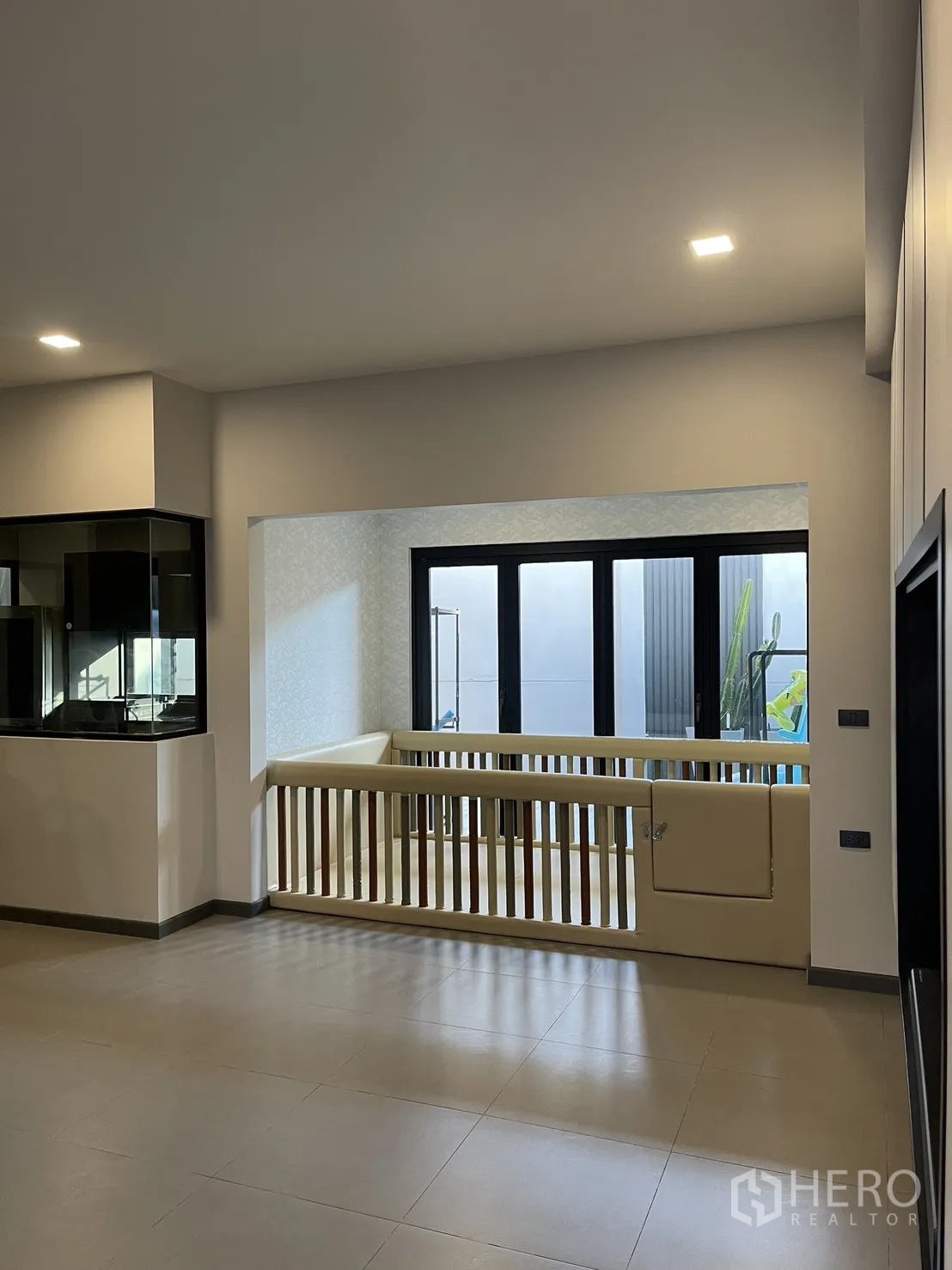Townhouse for sale in Bang Phli, Samut Prakan - Interior nook with large windows and a gated railing beside the patio.