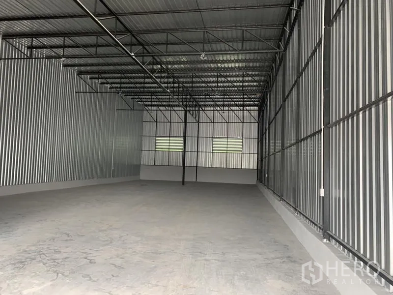 货栈 出租在Khlong Luang, Pathum Thani - 仓库内部，高钢结构屋顶，金属波纹墙，开阔混凝土地面