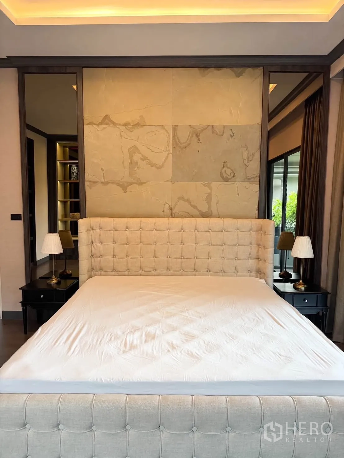 Detached House for rent in Bang Kapi, Bangkok - Master bedroom with tufted upholstered bed, bedside tables, and soft lighting.