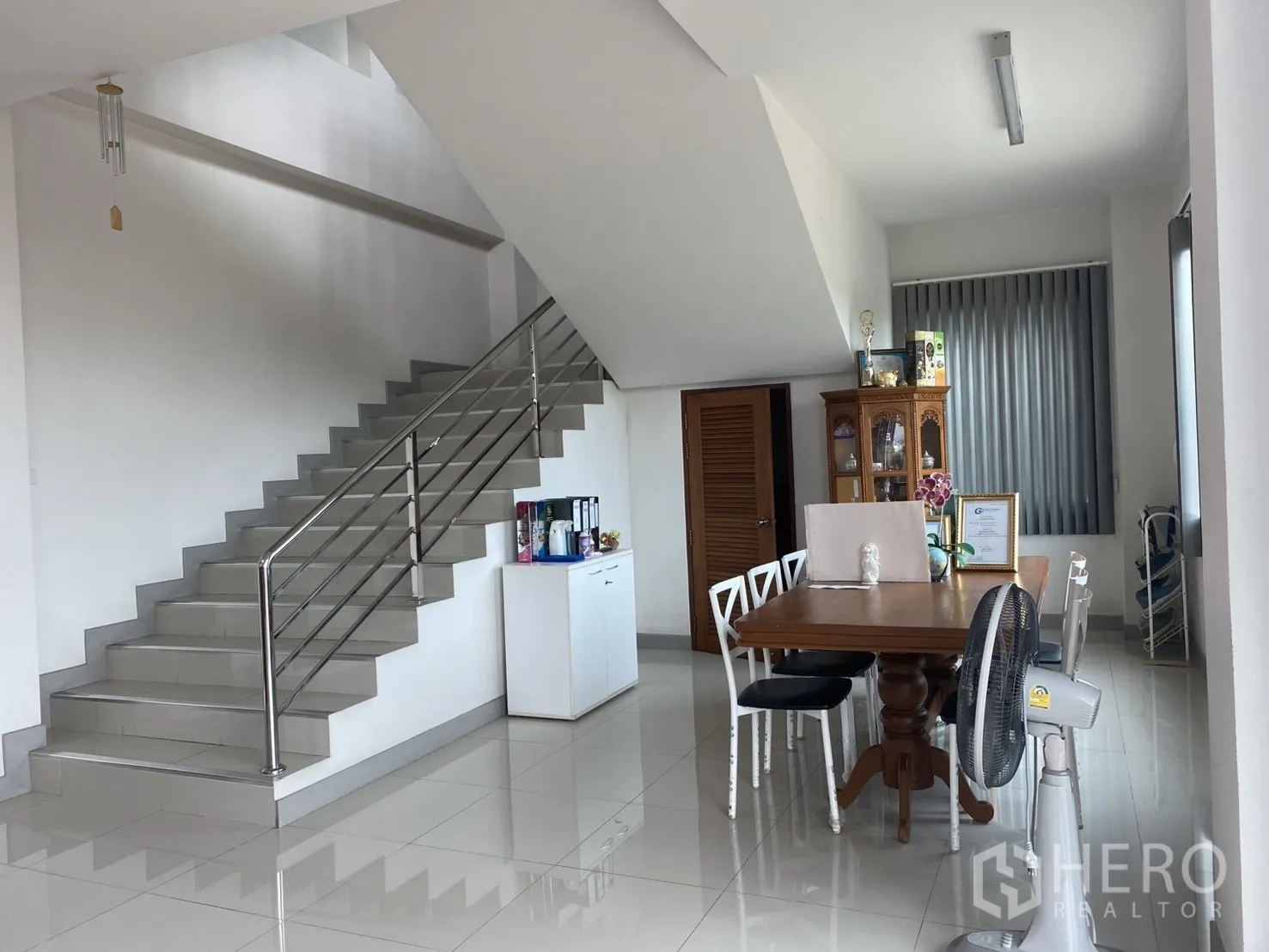 Factory for sale in Khlong Luang, Pathum Thani - Interior with staircase, meeting table, and glossy tile floors.