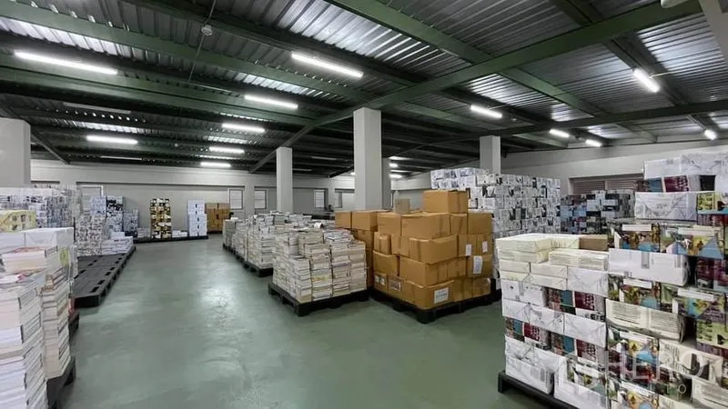 Warehouse for sale in Bangkok Yai, Bangkok - Spacious warehouse bay with stacked cartons and energy‑efficient lighting.