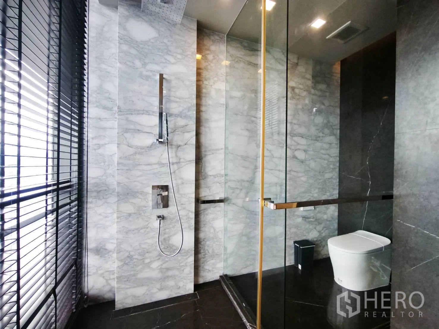 คอนโด for rent in Watthana, Bangkok - ห้องน้ำกรุหินอ่อนพร้อมฝักบัวเรนชาวเวอร์ กั้นกระจก และโถสุขภัณฑ์