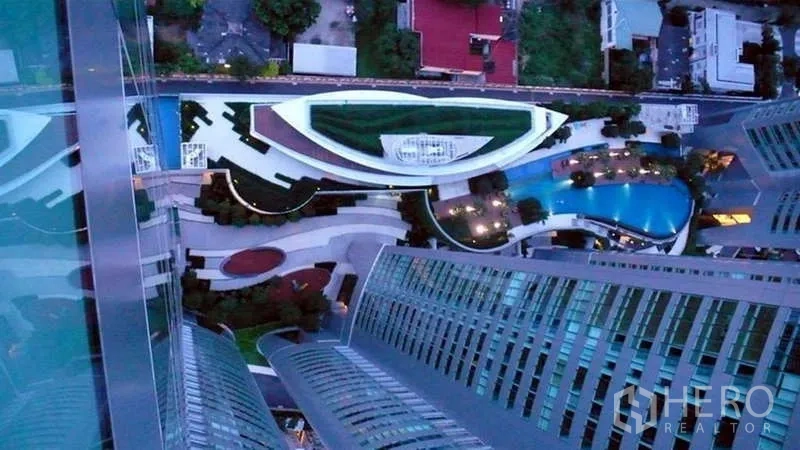 Condominium for rent or sale in Khlong Toei, Bangkok - Aerial view down to Millennium Residence landscaped podium and curving swimming pool between towers.