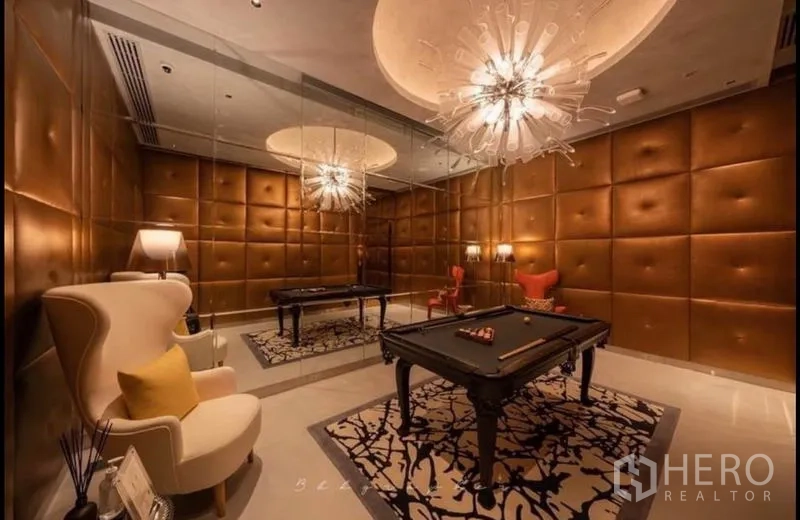 Condominium for rent or sale in Watthana, Bangkok - Luxury billiards lounge with mirrored wall, tufted leather panels and chandelier lighting.