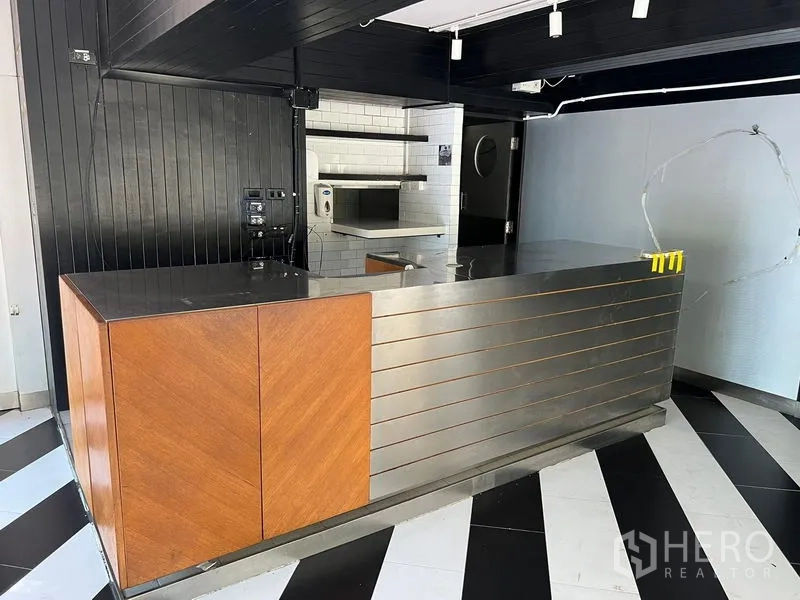 Retail Space for rent in Bang Rak, Bangkok - Stainless and wood service counter with a white-tiled prep area behind.