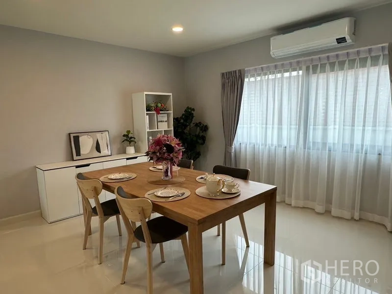Detached House for rent in Bang Phli, Samut Prakan - Alternate view of the dining area showing natural light, split-type air conditioner and minimalist decor.
