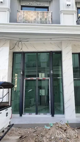 Home Office for rent in Suan Luang, Bangkok - Neo-classic home office facade with tall glass storefront and balcony.