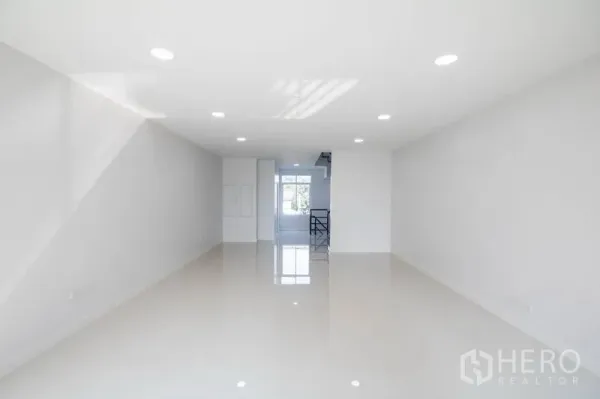 Home Office for sale in Huai Khwang, Bangkok - Long open-plan office floor with downlights and a windowed stairwell at the rear.