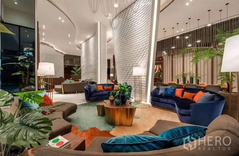 Condominium for rent - Hotel-style lobby lounge with plush sofas, greenery and statement lighting.
