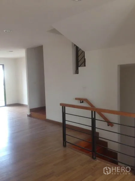 Home Office for rent in Bang Phli, Samut Prakan - Internal staircase and landing with metal railing and wooden steps.