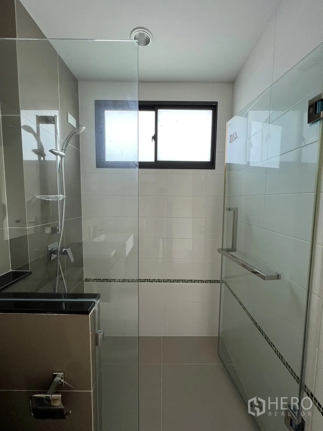 Detached House for sale in Suan Luang, Bangkok - Shower room with clear glass enclosure and tiled walls.