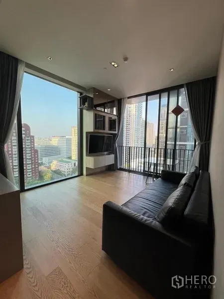 Condominium for rent - Corner living area with panoramic windows and open city view.