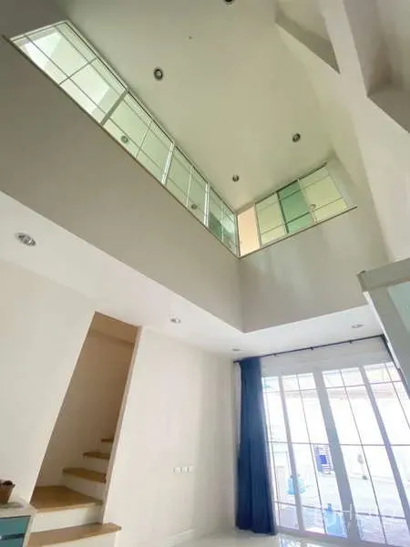 Home Office for rent or sale - Atrium view to the mezzanine with large interior windows and adjacent staircase.