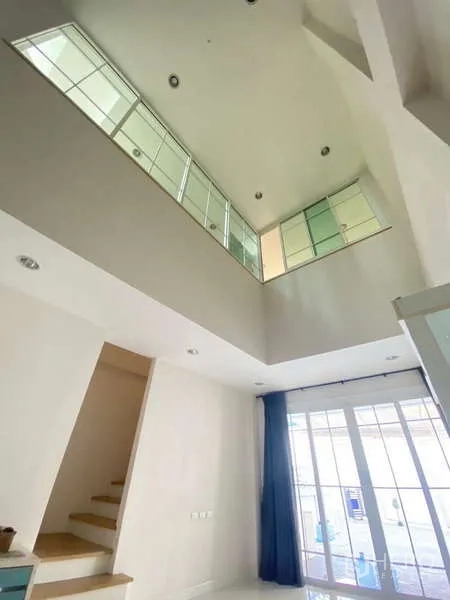 Home Office for rent or sale - Atrium view to the mezzanine with large interior windows and adjacent staircase.