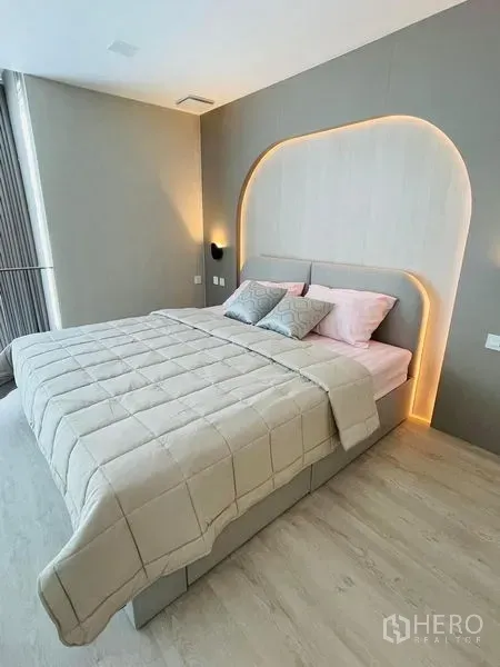 Detached House for rent - Cozy bedroom with arch-lit headboard, neutral tones and soft bedding.