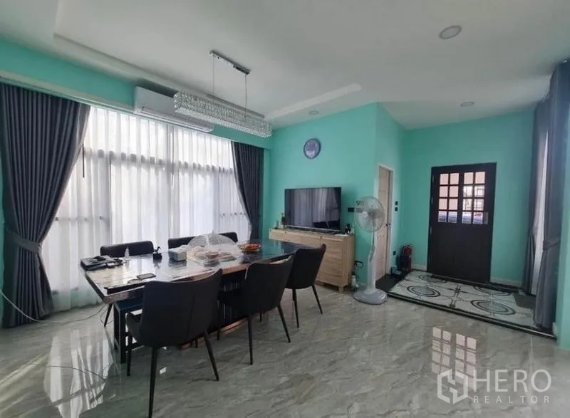 Detached House for sale in Sai Mai, Bangkok - Open dining area with floor-to-ceiling windows, crystal chandelier, and glossy floors.