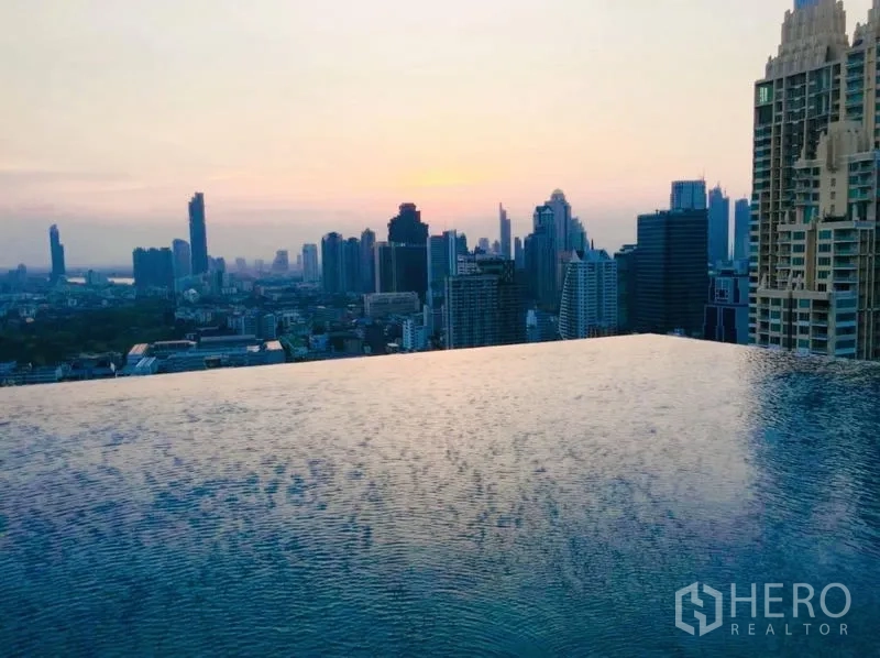 Condominium for rent or sale in Sathon, Bangkok - Rooftop infinity pool overlooking the Bangkok skyline at sunset.