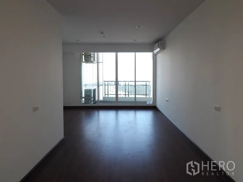 公寓 出租在Yan Nawa, Bangkok - 采光良好的卧室，深色木地板，空调，推拉玻璃门通往观景阳台。
