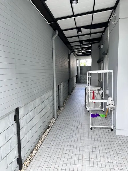 独立式住宅 出售在Prawet, Bangkok - 带顶服务走道，瓷砖地面，设置洗衣区。