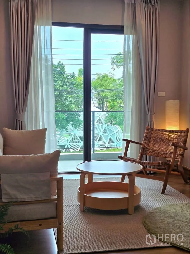 Detached House for rent or sale in Bang Phli, Samut Prakan - Cozy sitting nook opening to a balcony through sliding glass doors with green views.