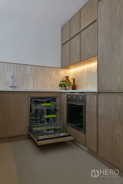 Detached House for rent in Watthana, Bangkok - Modern kitchen with built-in oven and pull-out dishwasher.