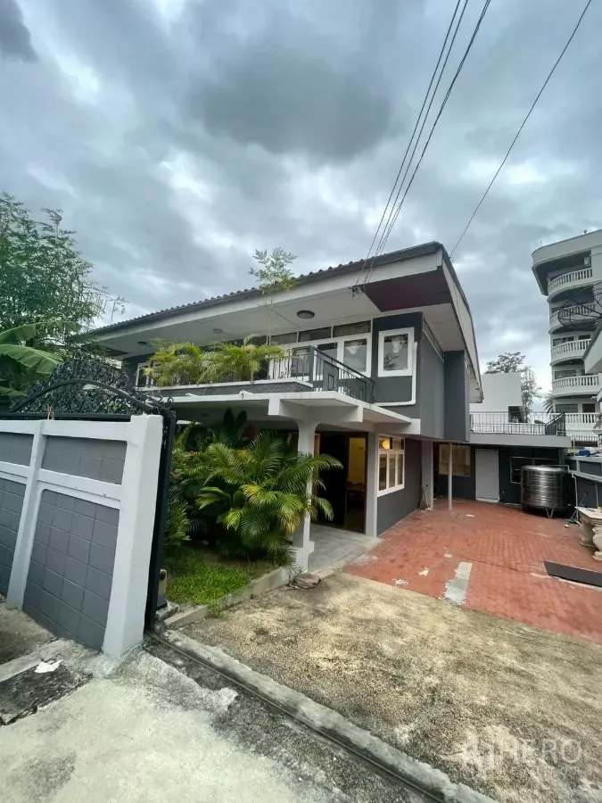 Detached House for rent in Watthana, Bangkok - Two-storey grey detached house with gated entrance, red-brick driveway and lush plants.