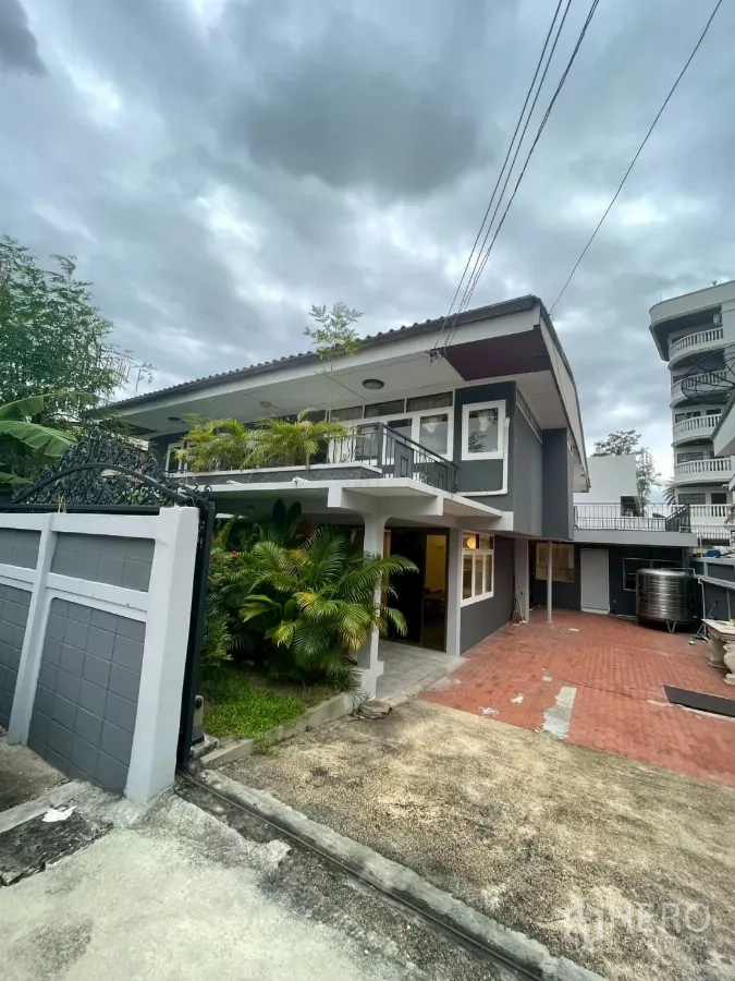 Detached House for rent in Watthana, Bangkok - Two-storey grey detached house with gated entrance, red-brick driveway and lush plants.