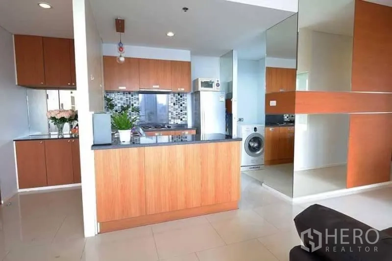 公寓 出租在Khlong San, Bangkok - 开放式厨房，木质橱柜、马赛克挡板与吧台，并配洗衣机。