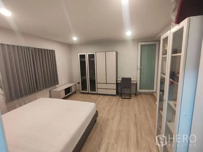 独立式住宅 出租在Prawet, Bangkok - 宽敞卧室另一视角，衣柜、书桌与玻璃门