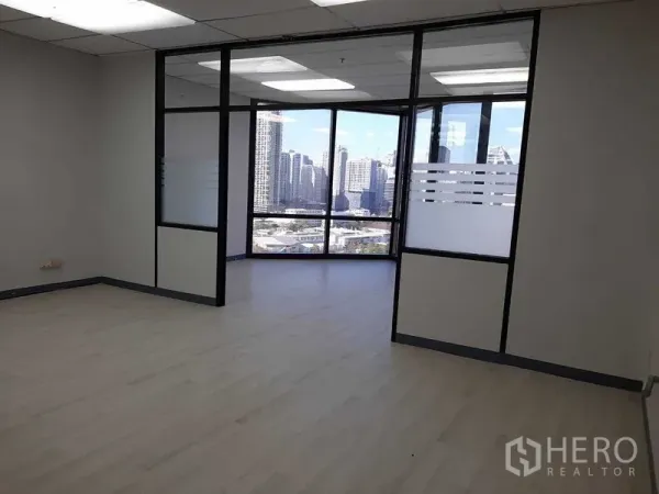 Office Space for rent in Khlong Toei, Bangkok - Main office area opening to a corner glass room with skyline backdrop.