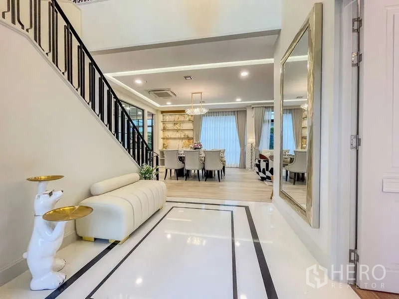Detached House for rent in Saphan Sung, Bangkok - Grand foyer leading to a chandelier-lit dining area and staircase.