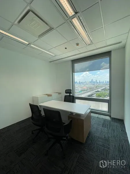 Office Space for rent in Dusit, Bangkok - Private office with desk and chairs facing a large window with Bangkok skyline view.